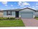 One-story home with two-car garage and landscaped front yard at 3166 Viceroy Ct, Poinciana, FL 34759