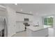 Open concept kitchen with white cabinets and stainless steel appliances at 3166 Viceroy Ct, Poinciana, FL 34759