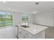 Modern kitchen with large island and access to patio at 3166 Viceroy Ct, Poinciana, FL 34759