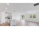 Open concept kitchen and living room with island and sliding glass doors at 3170 Viceroy Ct, Poinciana, FL 34759