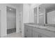 Double vanity bathroom with gray cabinets and granite counters at 3150 Viceroy Ct, Poinciana, FL 34759