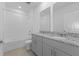 Bathroom with double vanity, granite countertop and bathtub at 3150 Viceroy Ct, Poinciana, FL 34759