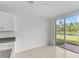 Bright dining area with sliding glass doors leading to the patio and pond view at 3206 Viceroy Ct, Poinciana, FL 34759