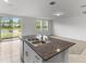 Kitchen with granite island, double sink, and view of backyard at 3206 Viceroy Ct, Poinciana, FL 34759