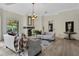 Elegant living room featuring a fireplace, plush sofas, and a stunning chandelier at 2417 Alaqua Dr, Longwood, FL 32779