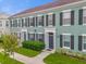 Modern light green townhouses with dark window shutters at 737 Siena Palm Dr # 737, Celebration, FL 34747