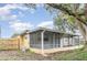 Covered patio with screen enclosure, overlooks a fenced backyard at 1916 Colton Dr, Orlando, FL 32822