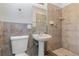 Clean bathroom with tile shower, pedestal sink, and toilet at 1916 Colton Dr, Orlando, FL 32822