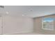 Bright bedroom with large window, neutral walls, and carpeted floors at 1608 Jefferson Dr, Mount Dora, FL 32757