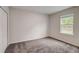 Simple bedroom with carpet and a large window at 1608 Jefferson Dr, Mount Dora, FL 32757