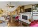 Open living room with hardwood floors, fireplace, and view into dining area at 4113 Fairview Vista Pt # 308, Orlando, FL 32804