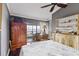 Bedroom with water view, ceiling fan, and built-in shelving at 4113 Fairview Vista Pt # 308, Orlando, FL 32804
