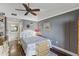 Bedroom with ceiling fan, gray walls, and access to bathroom at 4113 Fairview Vista Pt # 308, Orlando, FL 32804