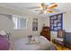 Cozy bedroom with a ceiling fan, wooden chair, and a dresser at 4113 Fairview Vista Pt # 308, Orlando, FL 32804