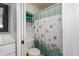 Clean bathroom featuring a shower/tub combo and seashell-themed decor at 4113 Fairview Vista Pt # 308, Orlando, FL 32804