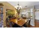 Dining room with wood table and chairs, kitchen view, and chandelier at 4113 Fairview Vista Pt # 308, Orlando, FL 32804