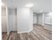Bright hallway with wood-look floors and white doors at 4455 Se 24Th St, Ocala, FL 34471