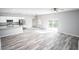 Open concept kitchen with island, stainless steel appliances, and wood-look flooring at 4455 Se 24Th St, Ocala, FL 34471