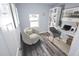 Virtually staged home office features built-in shelving and comfortable seating at 4455 Se 24Th St, Ocala, FL 34471