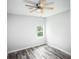 Bright bedroom with ceiling fan and wood-look floors at 4455 Se 24Th St, Ocala, FL 34471