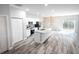 Open concept kitchen with island, stainless steel appliances, and wood-look flooring at 4455 Se 24Th St, Ocala, FL 34471