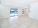 Bright living room with tile floors and sliding glass doors leading to a pool at 15639 Greater Groves Blvd, Clermont, FL 34714