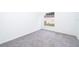 Bright bedroom with grey carpet and a view of the backyard at 15639 Greater Groves Blvd, Clermont, FL 34714