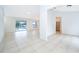 Open living room with tile floors and sliding doors leading to the pool at 15639 Greater Groves Blvd, Clermont, FL 34714