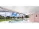 Screened-in pool area with a pink exterior wall at 15639 Greater Groves Blvd, Clermont, FL 34714