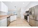 Modern kitchen with stainless steel appliances and light cabinets at 15639 Greater Groves Blvd, Clermont, FL 34714