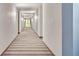 Long hallway with carpeted floors and modern lighting at 100 S Eola Dr # 1112, Orlando, FL 32801