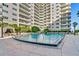 Inviting pool area with lounge chairs and building view at 100 S Eola Dr # 1112, Orlando, FL 32801