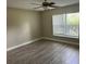 Spacious bedroom with wood-look flooring and large window at 2406 W Orange Blvd, Kissimmee, FL 34741