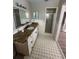 Bathroom with granite countertop, updated vanity, and tiled floor at 2406 W Orange Blvd, Kissimmee, FL 34741