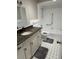 Clean bathroom with granite countertop, white cabinets, and tiled floor at 2406 W Orange Blvd, Kissimmee, FL 34741