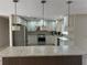 Updated kitchen featuring stainless steel appliances and white cabinets at 2406 W Orange Blvd, Kissimmee, FL 34741