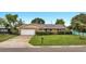Brick ranch house with attached garage and well-maintained lawn at 2406 W Orange Blvd, Kissimmee, FL 34741