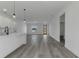 Open concept living and kitchen area with grey flooring and white cabinets at 526 Marion Oaks Trl, Ocala, FL 34473