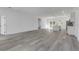 Open floor plan showing kitchen, living, and dining areas with grey flooring at 526 Marion Oaks Trl, Ocala, FL 34473