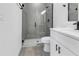 Modern bathroom with walk-in shower, white vanity, and gray tile at 526 Marion Oaks Trl, Ocala, FL 34473