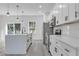 Modern kitchen featuring white cabinets, quartz countertops, and stainless steel appliances at 526 Marion Oaks Trl, Ocala, FL 34473