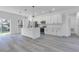 Modern kitchen with white cabinets, island, and stainless steel appliances at 526 Marion Oaks Trl, Ocala, FL 34473