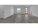 Spacious living room with wood-look flooring and a view from the window at 526 Marion Oaks Trl, Ocala, FL 34473