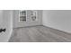 Bright bedroom with hardwood floors and two windows at 526 Marion Oaks Trl, Ocala, FL 34473