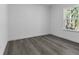 Simple bedroom with wood-look floors and a window with a view at 526 Marion Oaks Trl, Ocala, FL 34473