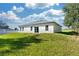 Rear view of a house showcasing a large backyard and patio at 526 Marion Oaks Trl, Ocala, FL 34473