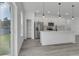 White kitchen with stainless steel appliances and an island at 526 Marion Oaks Trl, Ocala, FL 34473