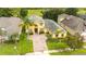 Large two story house with a driveway and lush landscaping at 7315 Windham Harbour Ave, Orlando, FL 32829