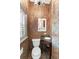 Powder room with decorative wallpaper, pedestal sink, and unique tile flooring at 732 Edgewater Dr, Orlando, FL 32804