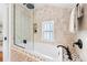 Modern bathroom featuring a glass-enclosed bathtub and tiled walls at 732 Edgewater Dr, Orlando, FL 32804